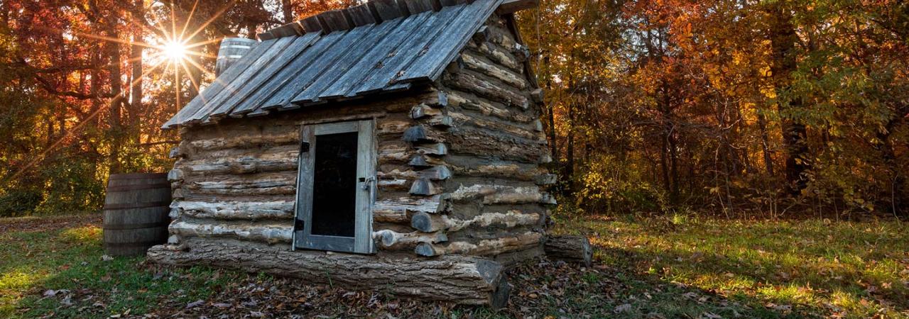 Replica civil war quarters with an Autumn backdrop at Bristoe Station Battlefield in Bristow, VA.