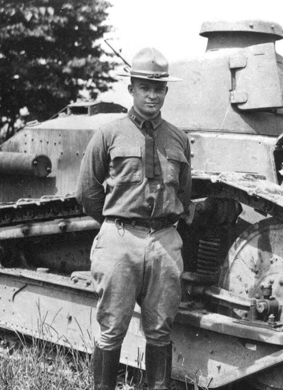 A black and white photo of Maj. Dwight D. Eisenhower beside a Renault light tank