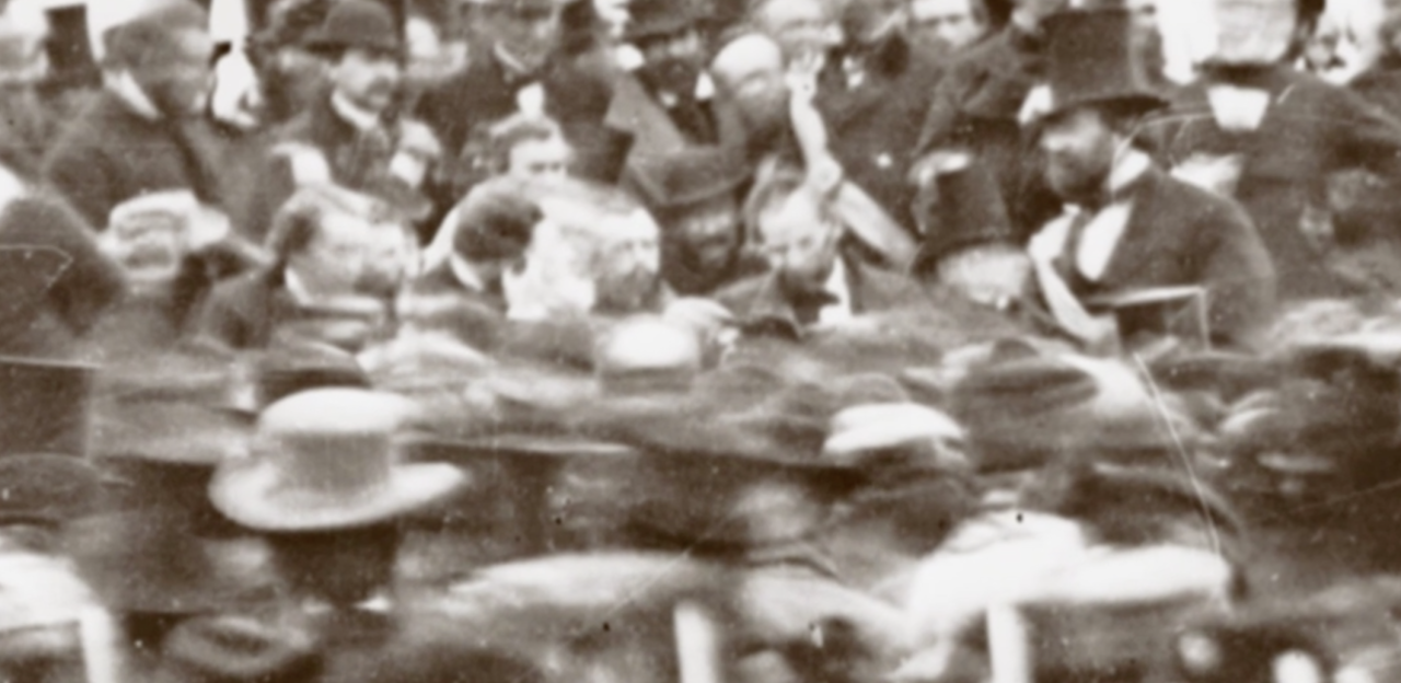 Photo of a crowd gathering around Lincoln during his Gettysburg Address