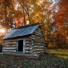 Replica civil war quarters with an Autumn backdrop at Bristoe Station Battlefield in Bristow, VA.