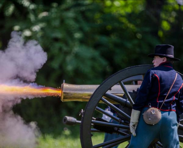 Living history volunteers portraying members of Battery B, 4th US present an artillery demonstration at Gettysburg National Military Park, Pa.