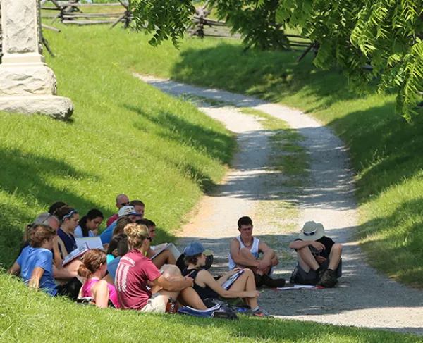 This is an image of a tour group sitting on the Antietam battlefield.