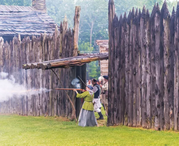 This is an image of a woman firing a gun from Logan's Fort.