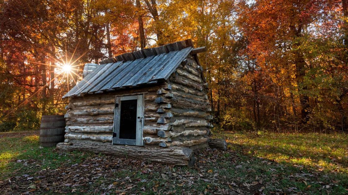 Replica civil war quarters with an Autumn backdrop at Bristoe Station Battlefield in Bristow, VA.