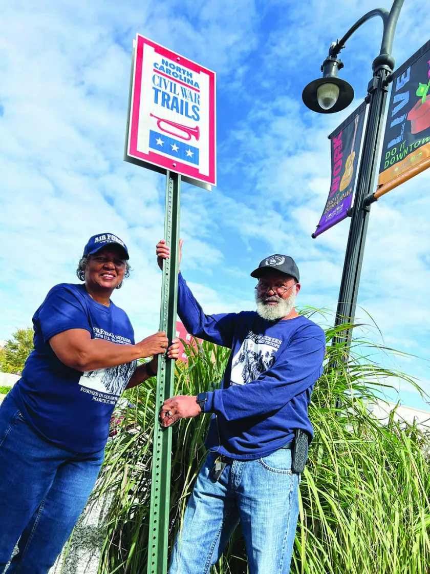 Members of the 135th USCT Research Group install their sign in Goldsboro, N.C.