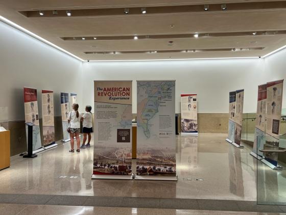 Visitors peruse the American Revolution Experience traveling exhibit on display at the Virginia State Capitol in June 2024.