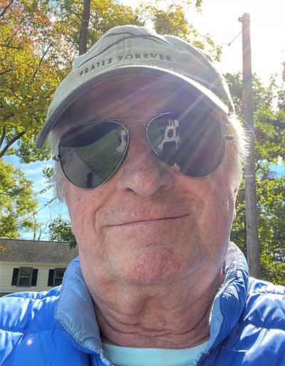 A photograph of Color Bearer Michael Hardy outdoors wearing sunglasses and a baseball cap